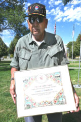 Vietnam Veteran and Commander of the Southern Ute
Veterans Association, Howard Richards Sr., holds a
certificate of recognition given to him by Father Cesar Arras, CR Theat. of the St. Ignatius Parish.