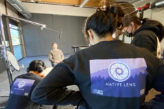Native Lens Fellows Isreal Duran (left), Laelah Kizzia (middle), Shannon Spencer (right) film an interview of Bird Red (background) for their film ‘Culture Within the Ice” as part of the 2023 Native Lens Media Fellowship program.