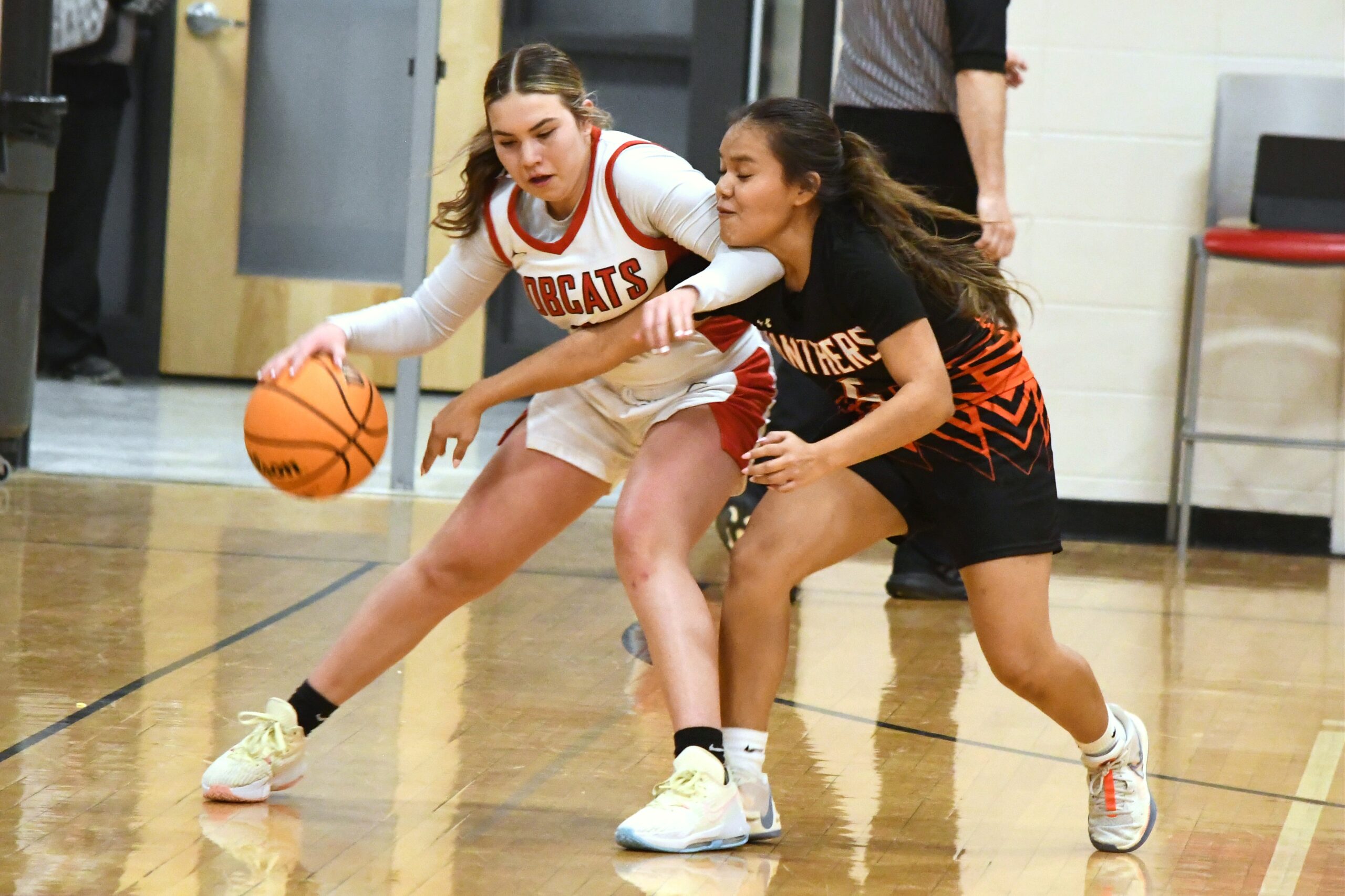 Ignacio junior Marissa Olguin (left) tries keeping the ball safely away from Montezuma-Cortez's Trenity Tillahash (5) during IHS' 58-44 home loss Thursday evening, Feb. 15. It was the last regular-season game for both teams; Olguin's 15 points paced IHS offensively.