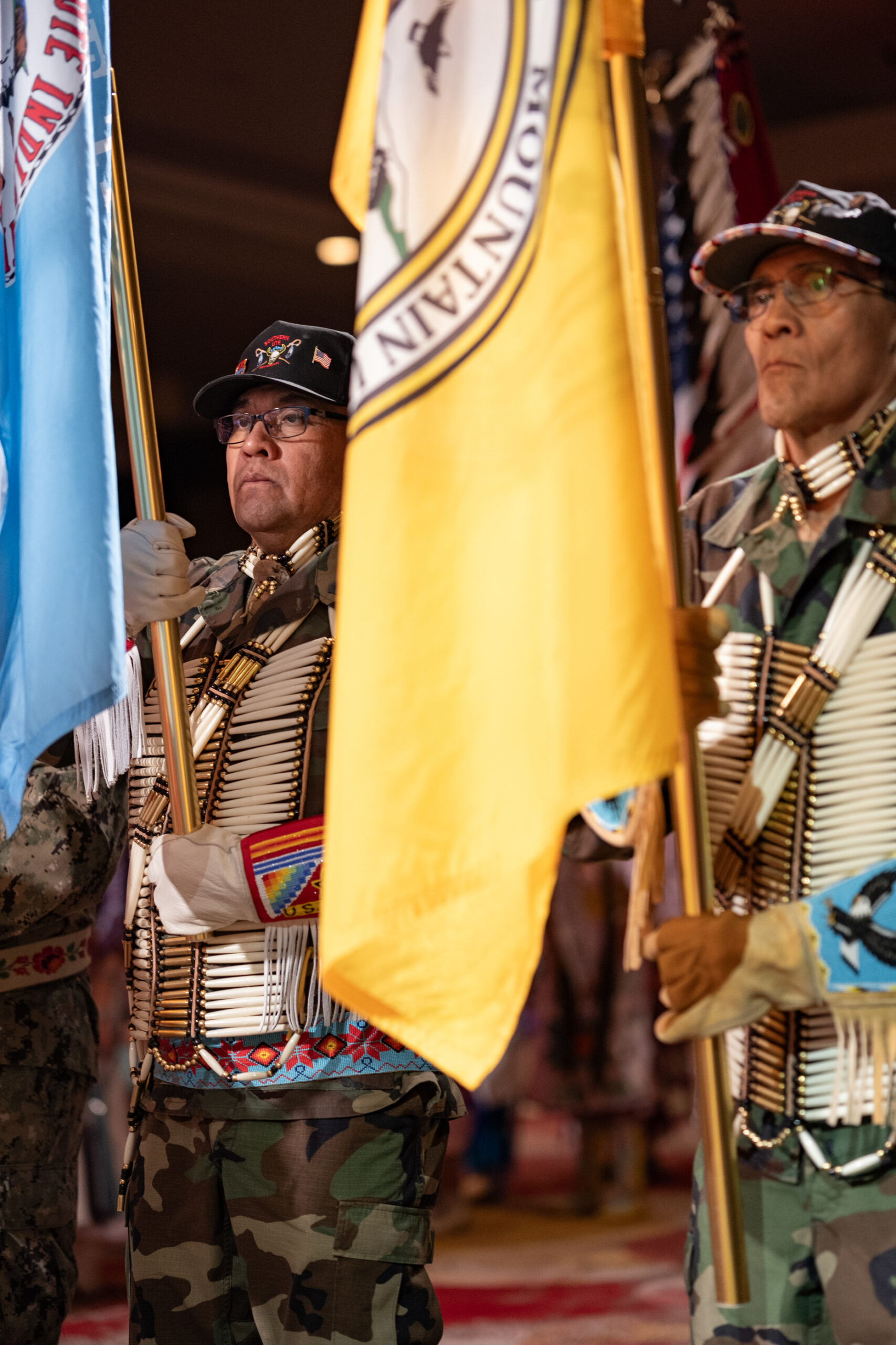 Carrying the colors — Southern Ute Veterans Association members, Bruce Valdez (U.S. Army) brings in the Southern Ute tribal flag, and Gordon Hammond (U.S. Marines), brings in the Ute Mountain Ute tribal flag ahead of Grand Entry, Saturday, Feb. 10.