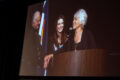 Thumbnail image of Ben’s wife Linda Campbell shares a moment of embrace on stage with their two children, Shanan and Colin.